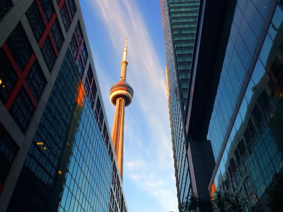 The CN Tower seen between glass office towers in downtown Toronto